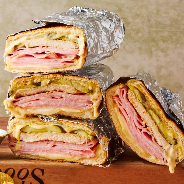mojo marinated roast pork, thinly sliced deli ham, melty swiss cheese, and tangy dill pickles piled onto a cuban roll and griddled to golden brown perfection
