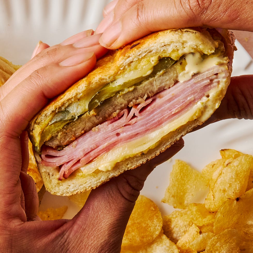 mojo marinated roast pork, thinly sliced deli ham, melty swiss cheese, and tangy dill pickles piled onto a cuban roll and griddled to golden brown perfection