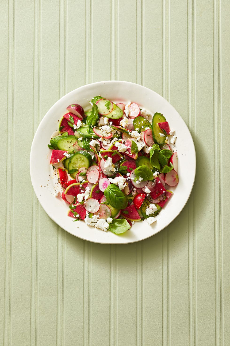 cucumber radish salad with feta sprinkled on top