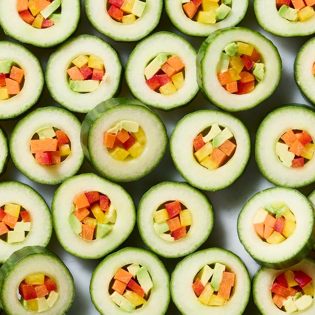 hollowed out cucumber circled filled with veggies and served with spicy mayo