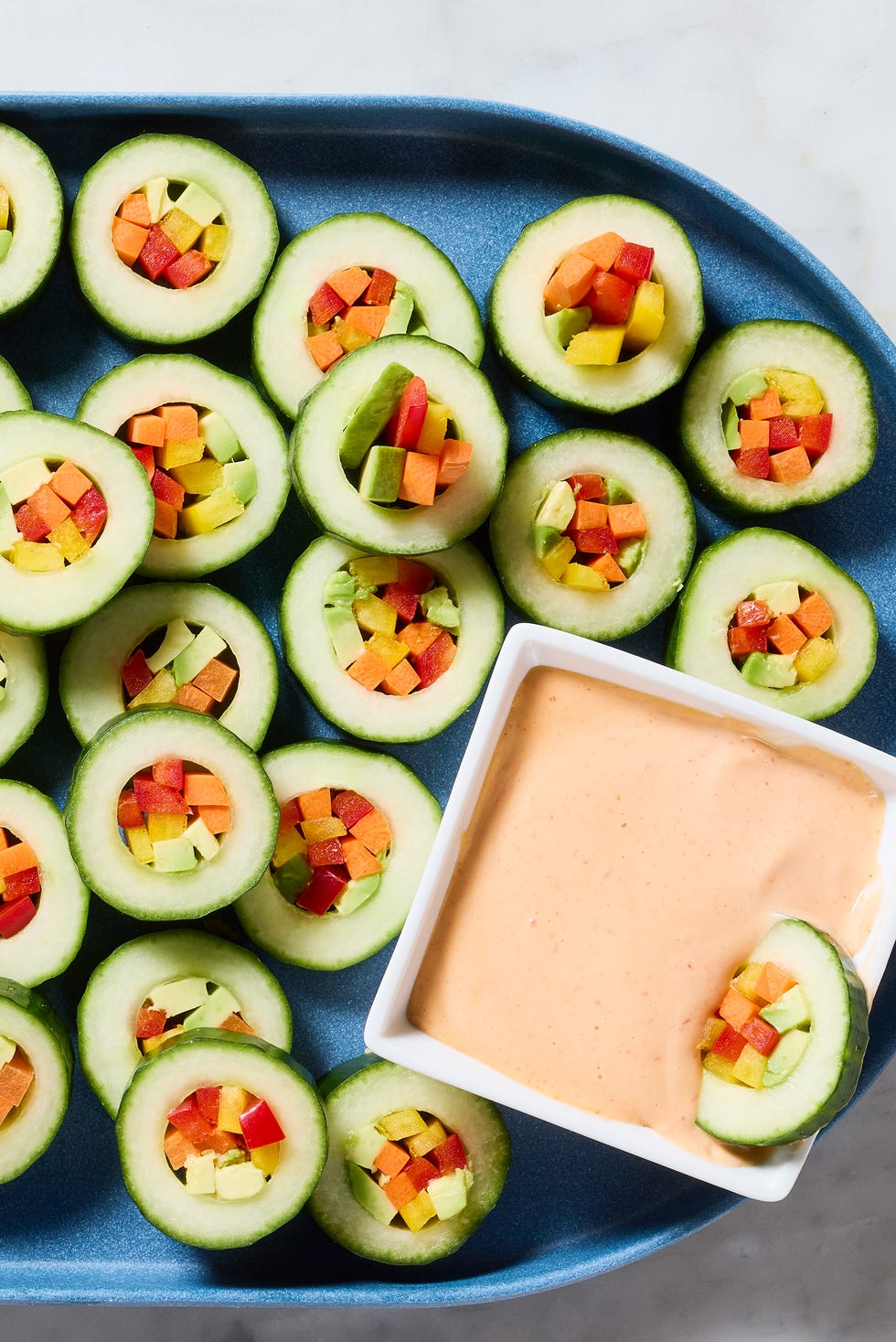 hollowed out cucumber circles with veggies in the middle