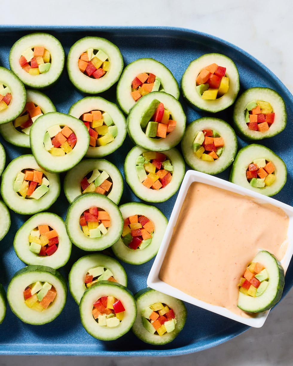 hollowed out cucumber circled filled with veggies and served with spicy mayo