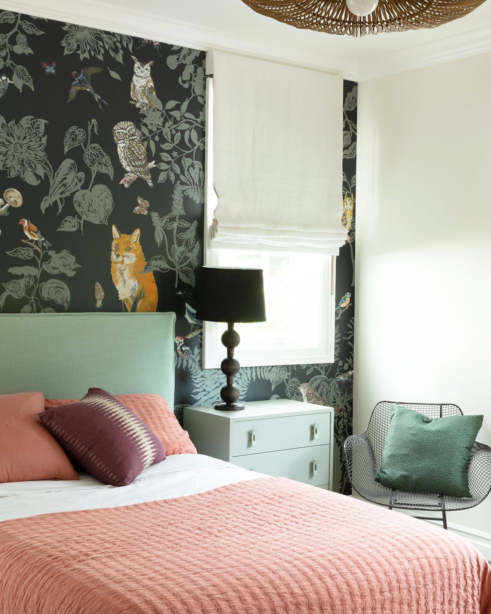 bedroom with coral bedding and green wallpaper