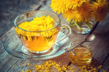 cup of healthy dandelion tea and honey herbal medicine