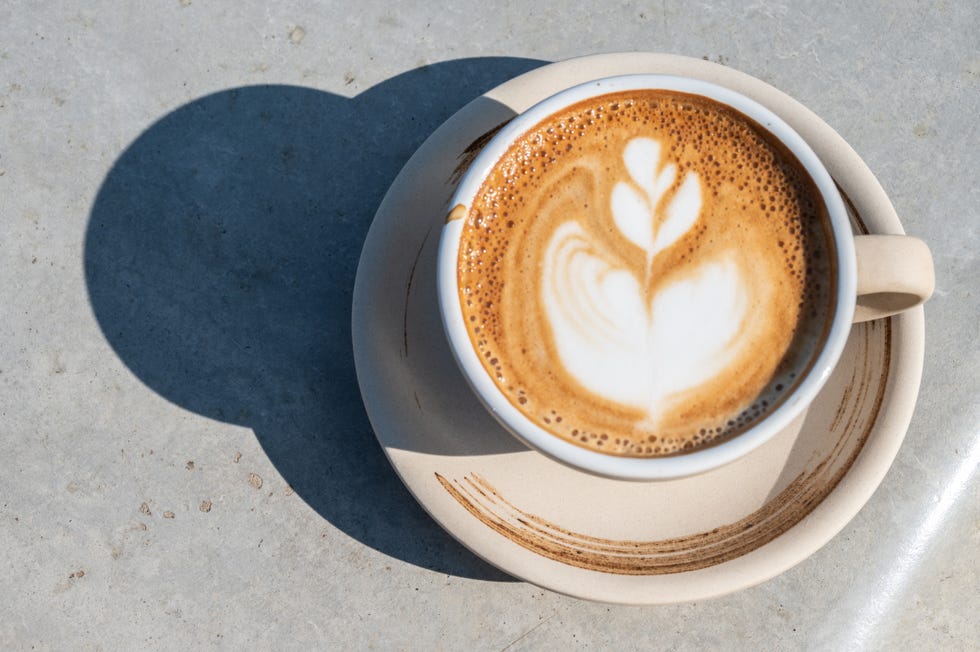 a cup of latte coffee on table