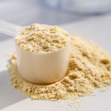 cup of protein powder on white table