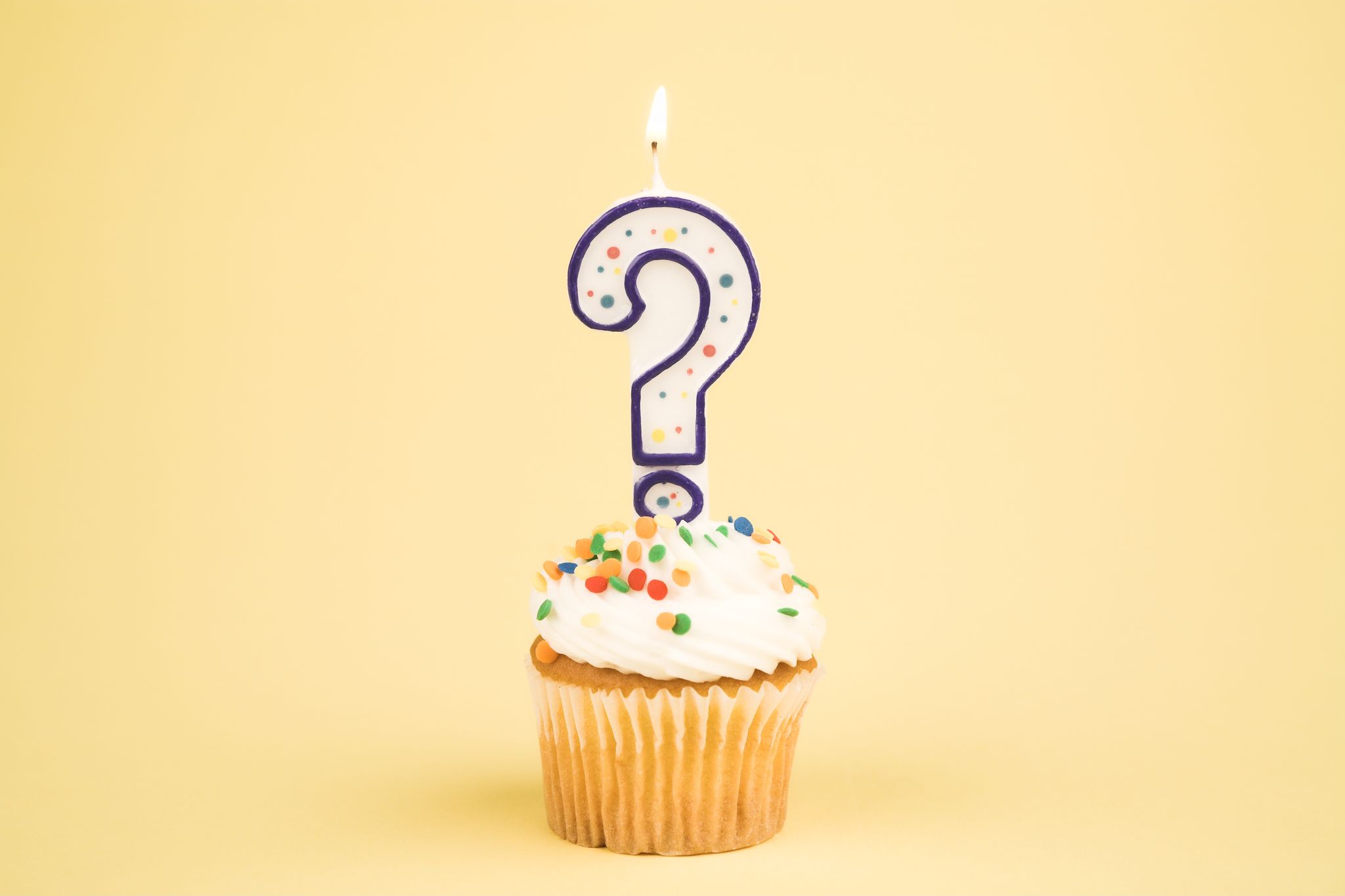 question mark birthday candle on cupcake