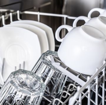 white cups in new dishwasher close up clean dishes housekeeping devices