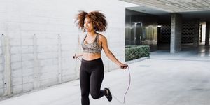 curvy african american woman skipping rope in urban area