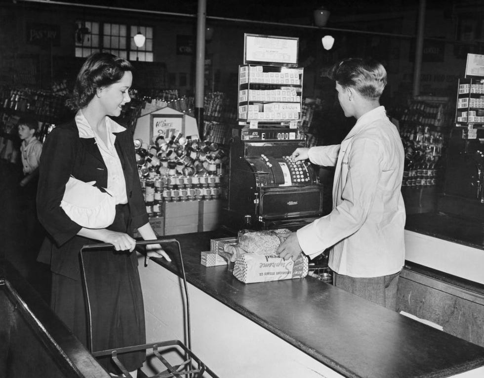customer paying cashier at supermarket