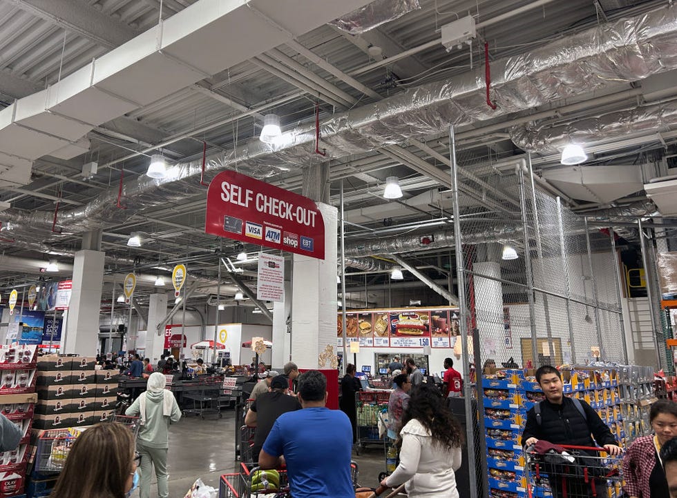 customers using self checkout machines at costco store, queens, new york