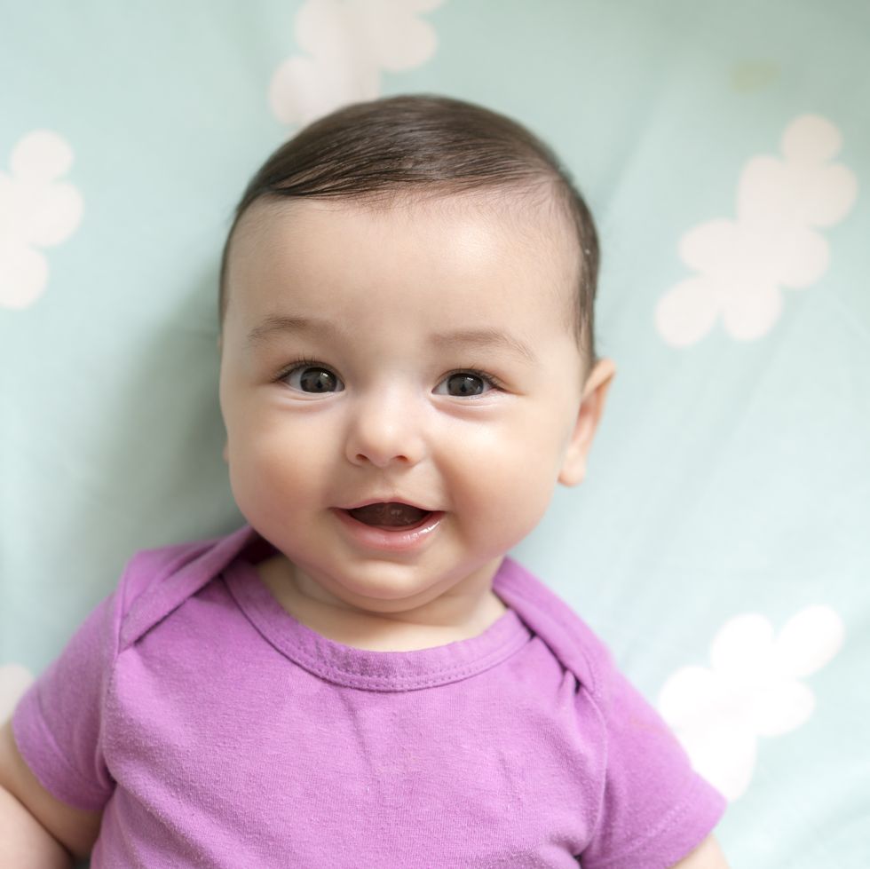 cute baby girl lying in bed