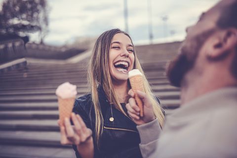 cute female eating ice cream with boyfriend