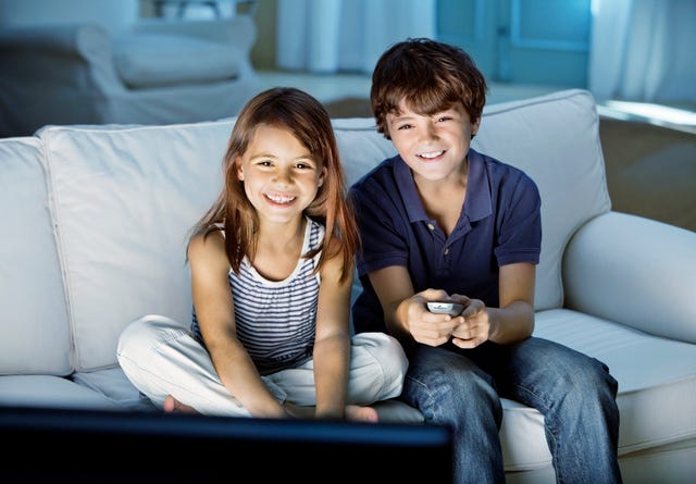Cute kids watching television