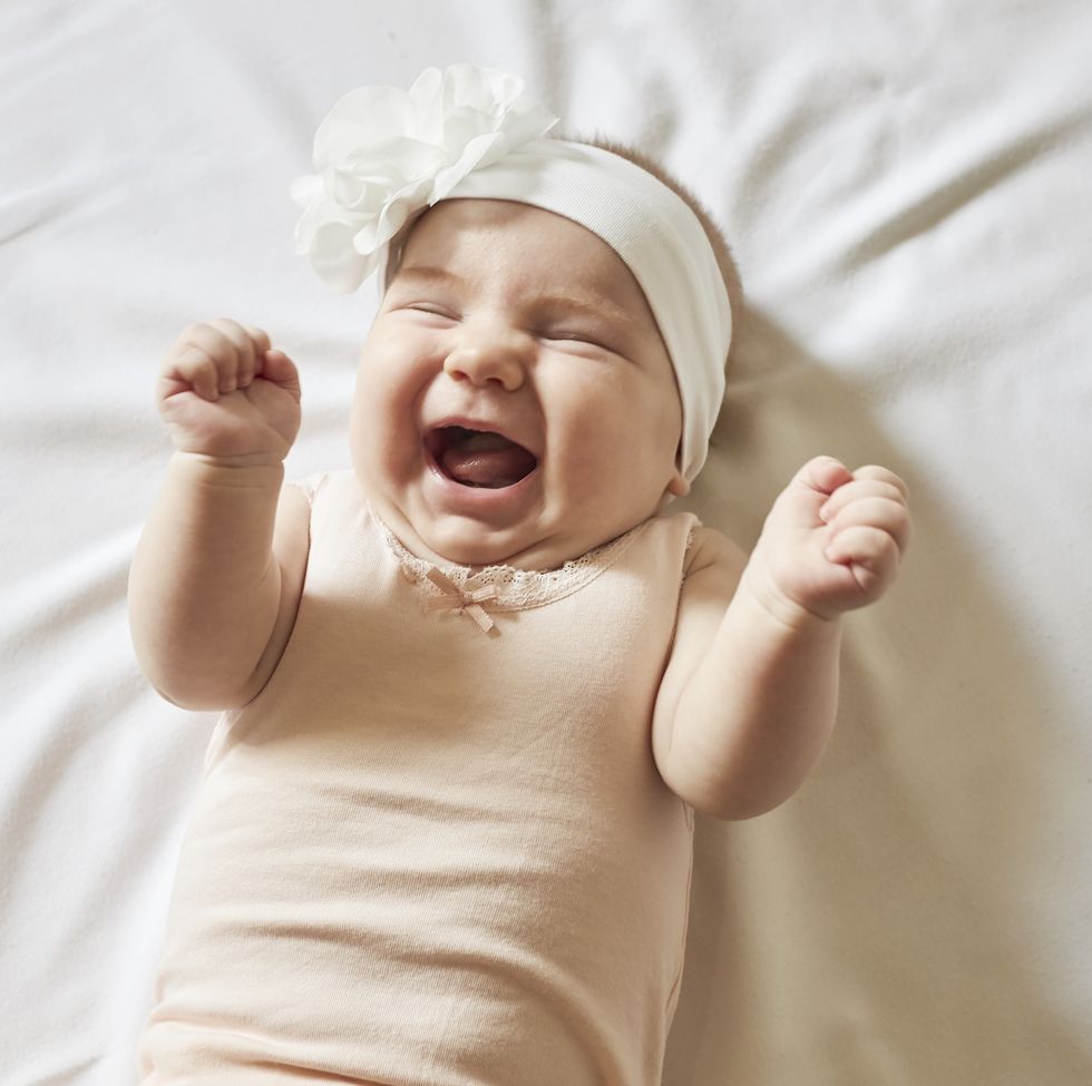 caucasian baby girl laying in grass