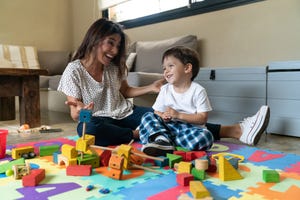 mujer y ninos sonrientes y jugando