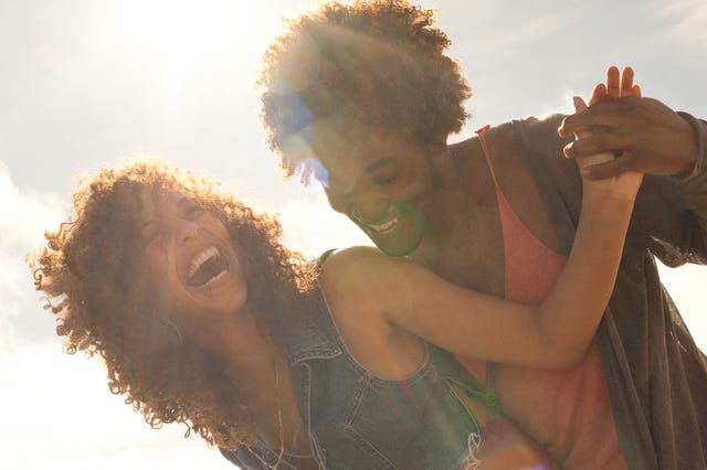 a happy couple hugging in the sunlight to illustrate a story on cute nicknames for boyfriends