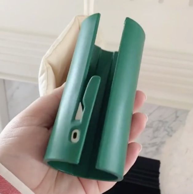 green gift wrap cutter that looks like a cylinder