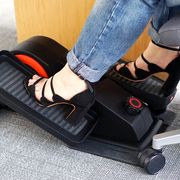 person wearing jeans and heels using cuubi under desk elliptical