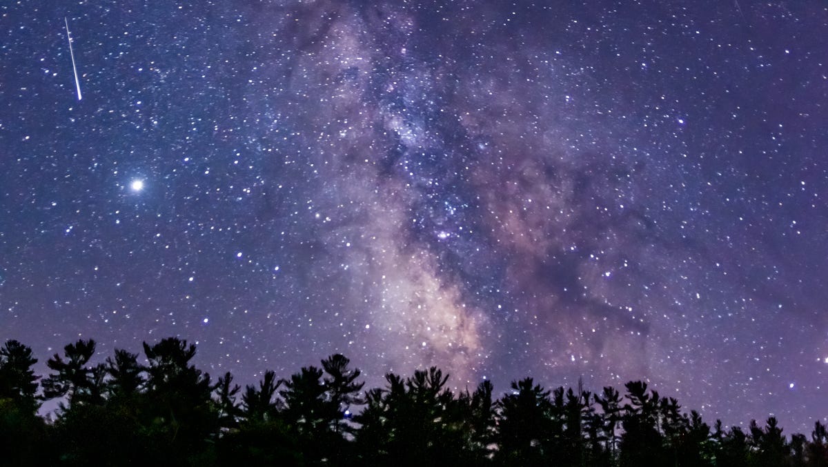 a long exposure of the milky way and a shooting star