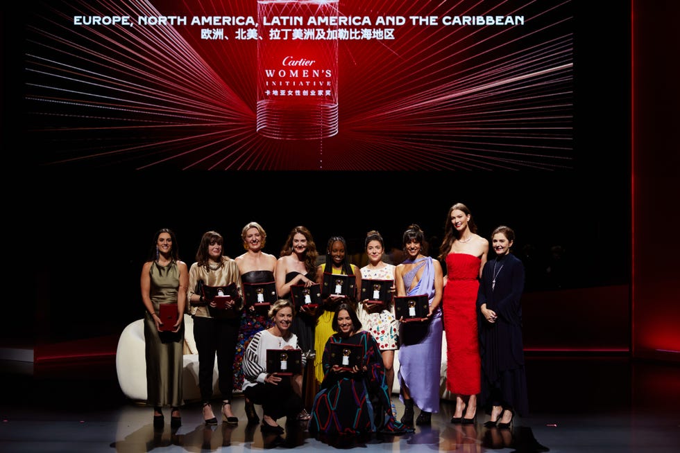 honorees gathered on a stage holding awards