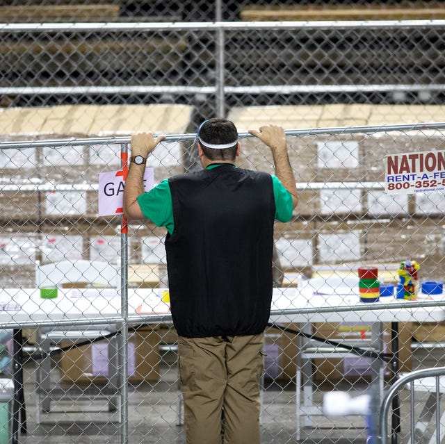 phoenix, az   may 03 a contractor working for cyber ninjas, who was hired by the arizona state senate, looks at ballots from the 2020 general election on may 3, 2021 in phoenix, arizona photo by courtney pedroza for the washington post