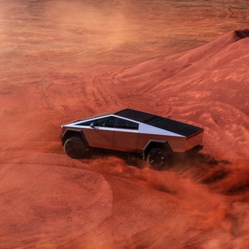 tesla cybertruck driving through a desert