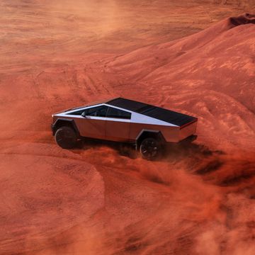 tesla cybertruck driving through a desert