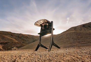 high chair positioned on barren terrain with mountains in the background