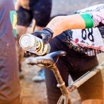 cyclist handing off beer at cyclocross event