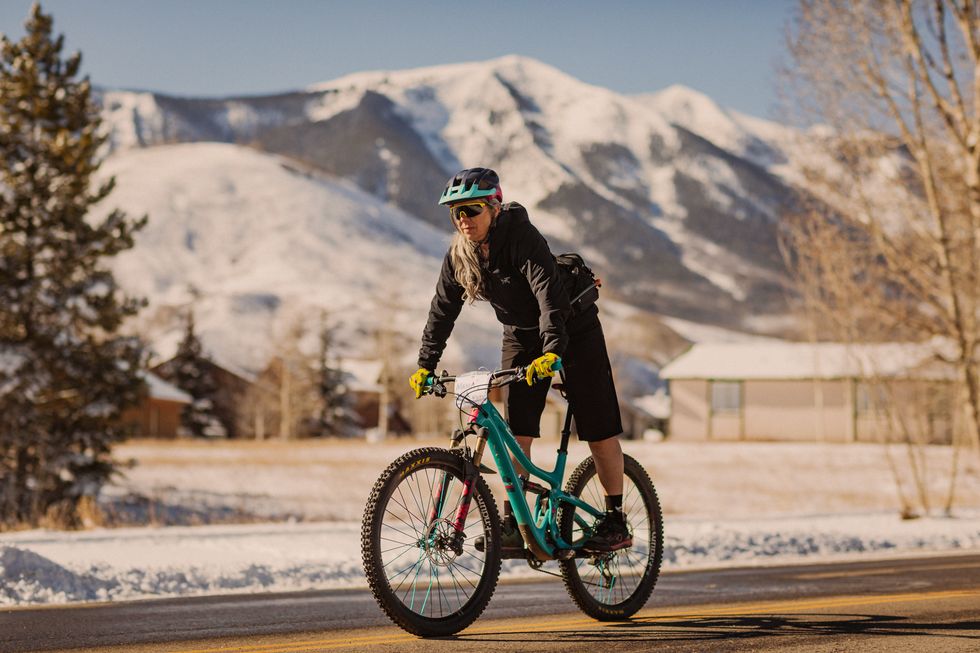 mia phillips riding bike on road in crested butte co