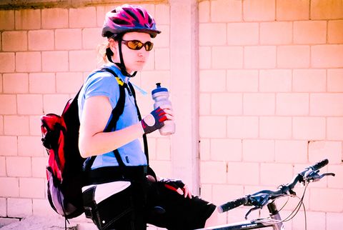 cyclist drinking water from water bottle