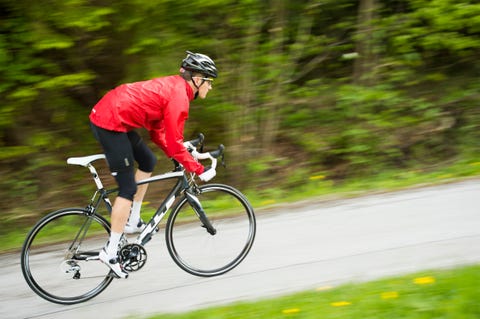 Cyclist in red shirt practicing