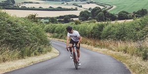 cyclist on country road going uphill