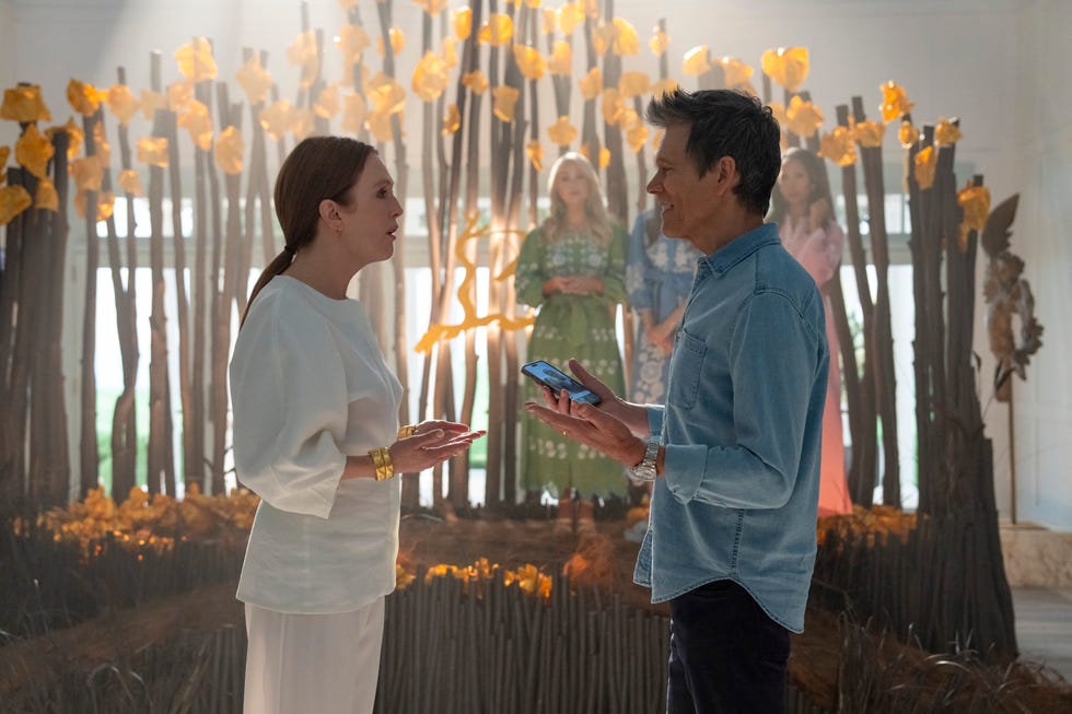 A conversational interaction between two individuals in a setting adorned with sticks and yellow decorations.