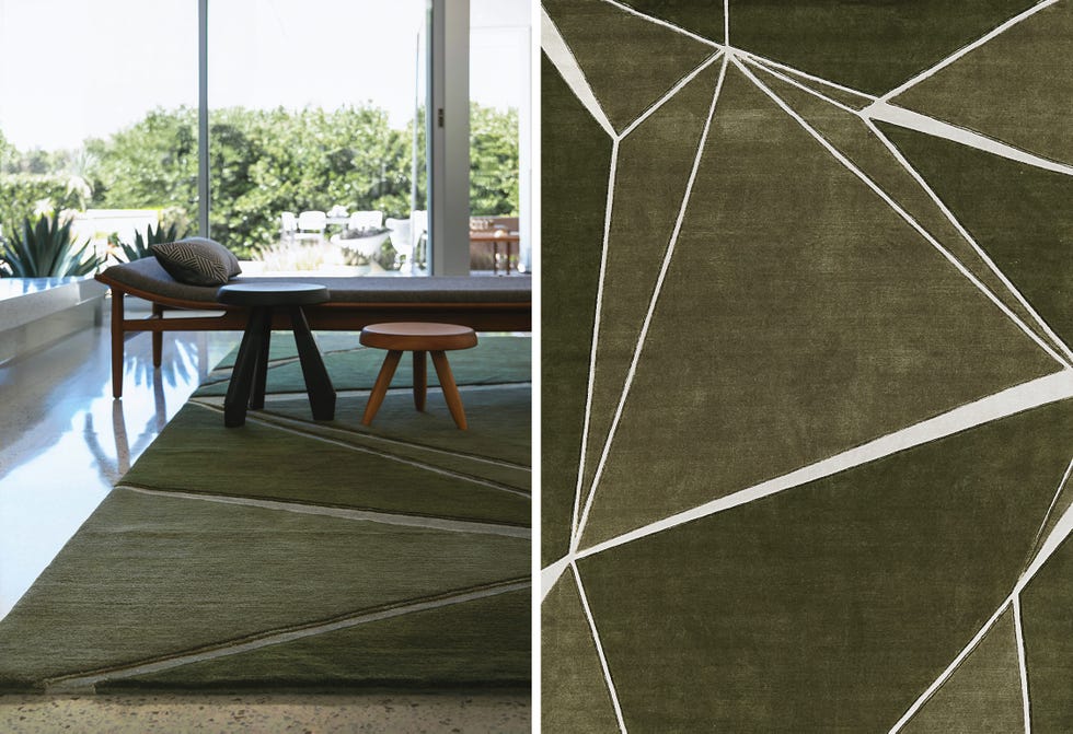 A contemporary living space featuring a geometric rug and furniture.