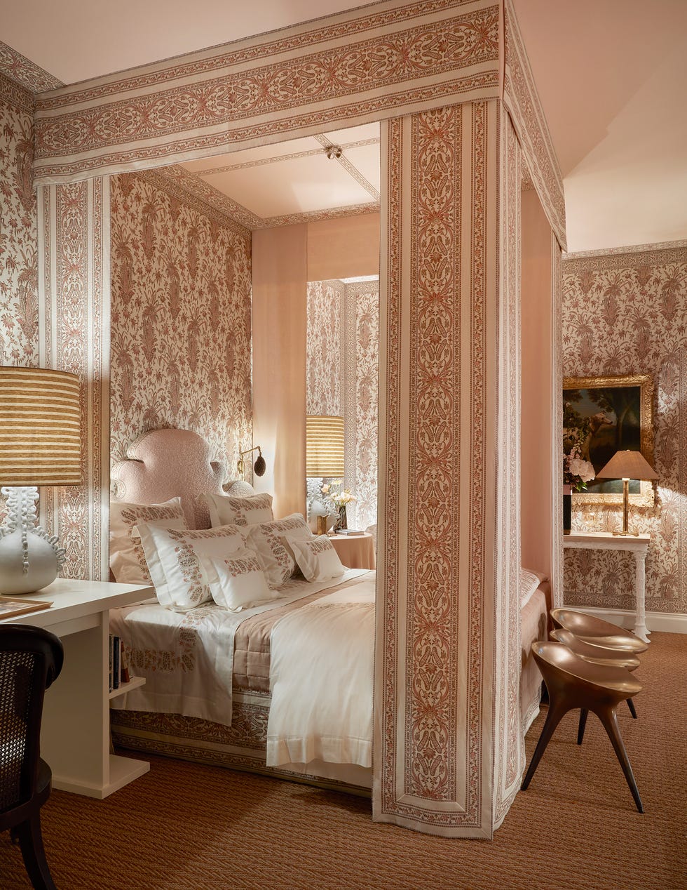 Elegant bedroom with floral-patterned wallpaper and sophisticated decor.
