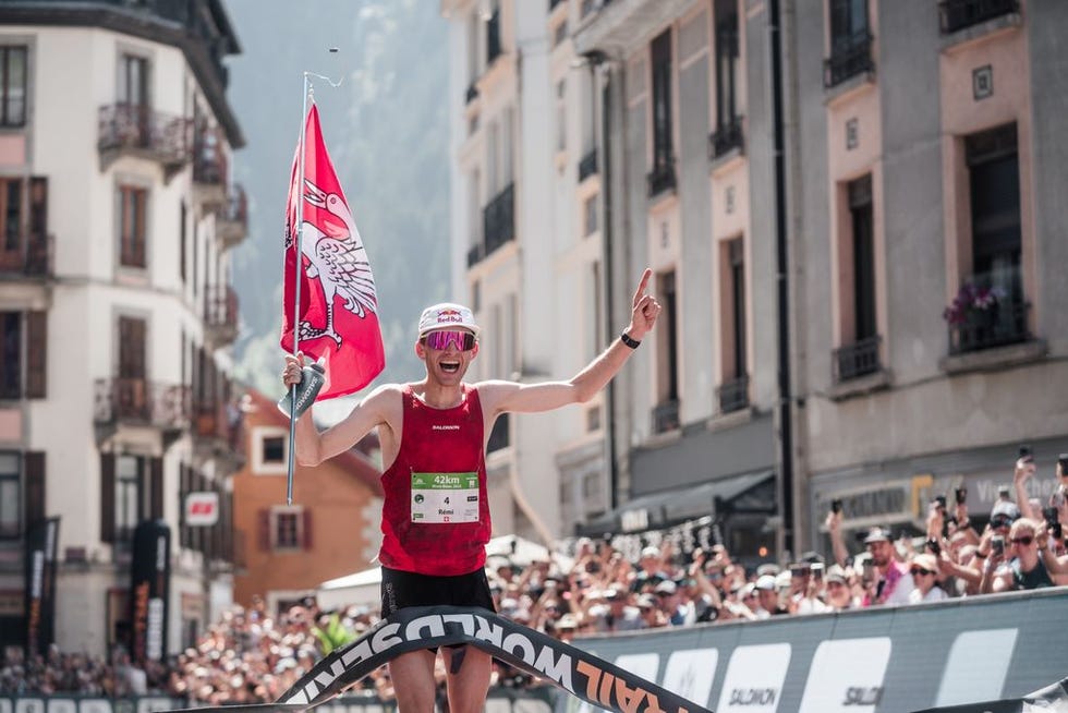 a person holding a flag and a flag in front of a crowd