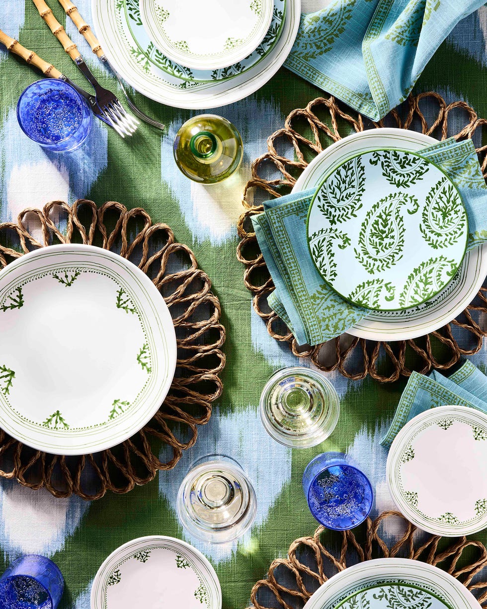 tablescape featuring blue, green and natural plates and linens and glassware