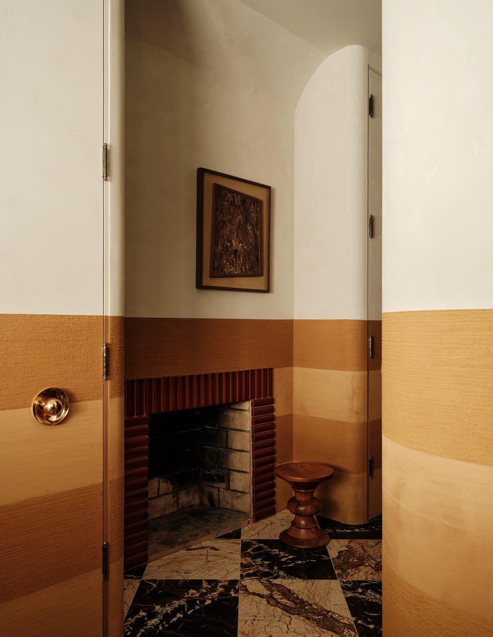 Interior corner featuring a fireplace and artistic decor.