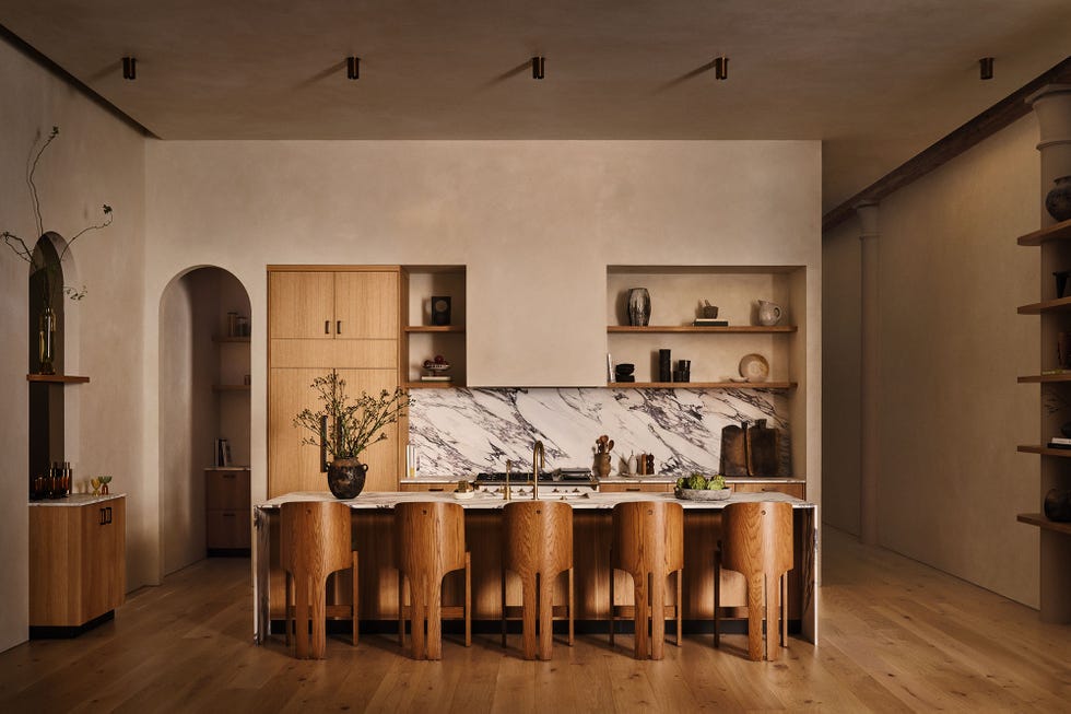 Modern kitchen with minimalist design, featuring a marble backsplash and wooden furniture.