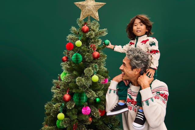 dad son decorating christmas tree