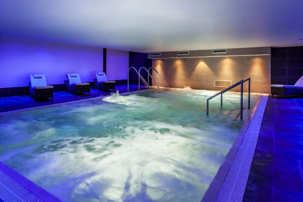 a swimming pool with steps and a lounger