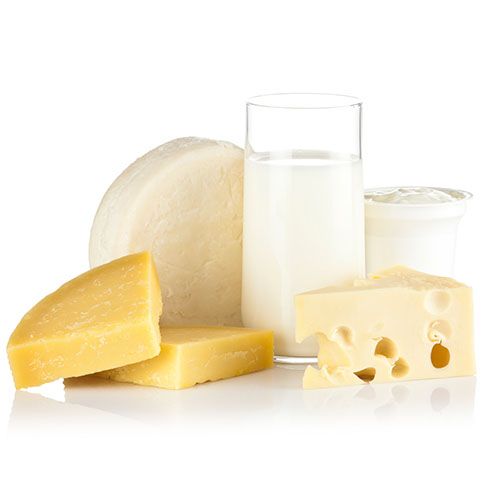 dairy products, including a glass of milk and various cheeses