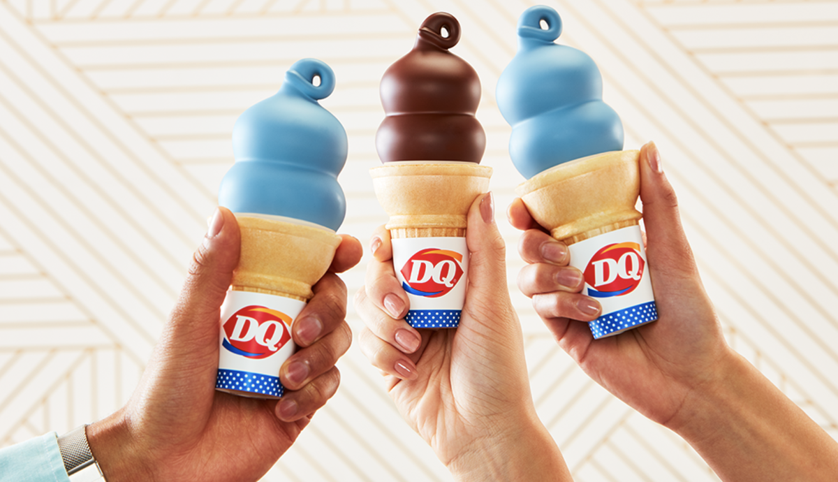 hands with dairy queen dipped cones in them