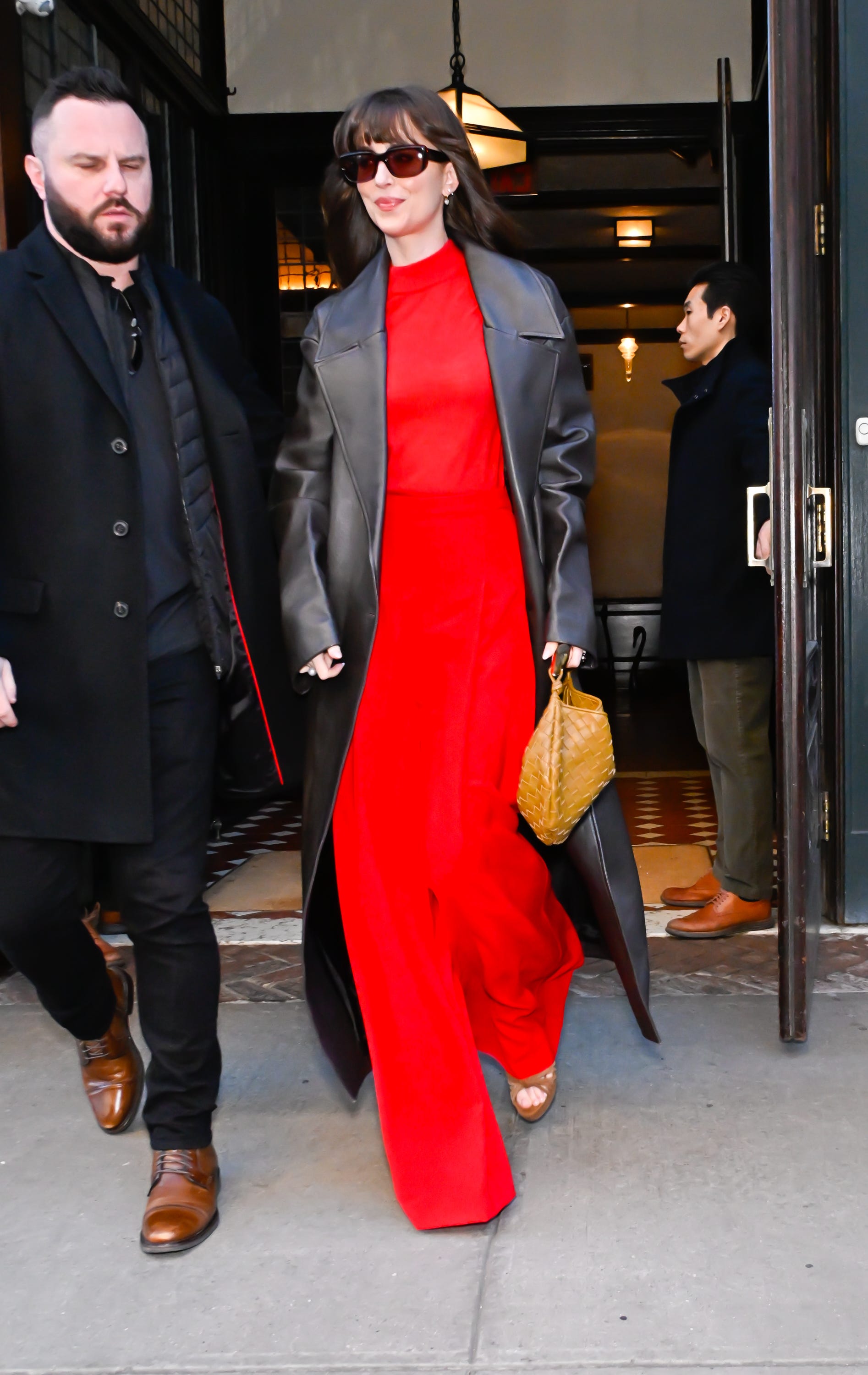 Dakota Johnson Accessorizes Her Candy Apple Red Set with an Enviable Woven Bag