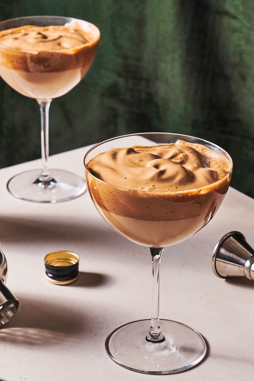 dalgona whipped coffee cocktail in a coupe glass