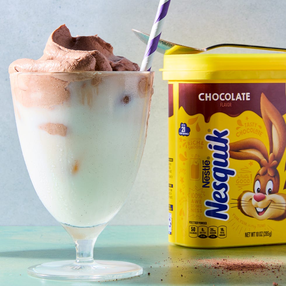 whipped chocolate in a frosted glass with a blue and white straw