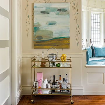 a room with a shelf and a painting on the wall