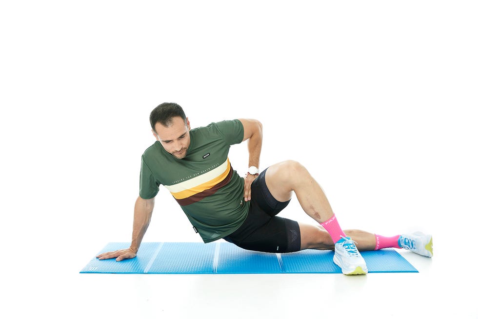 a man stretching on a mat